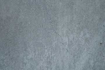 Grunge textured concrete wall surface with cracks and rough grain, providing a weathered grey industrial background or distressed abstract overlay, showing decay and urban architecture details © Vero Dibe