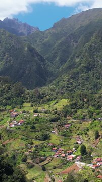 Explore the stunning aerial view of Madeira's majestic mountains, lush landscapes, and charming villages. Discover the beauty of rural living in this picturesque region of Portugal.