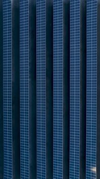 Solar Energy Technology Center with Rooftop Solar Panels, Ground-Mounted Arrays and Photovoltaic Research Systems in Florian&oacute;polis, Brazil. Aerial View. Vertical video.