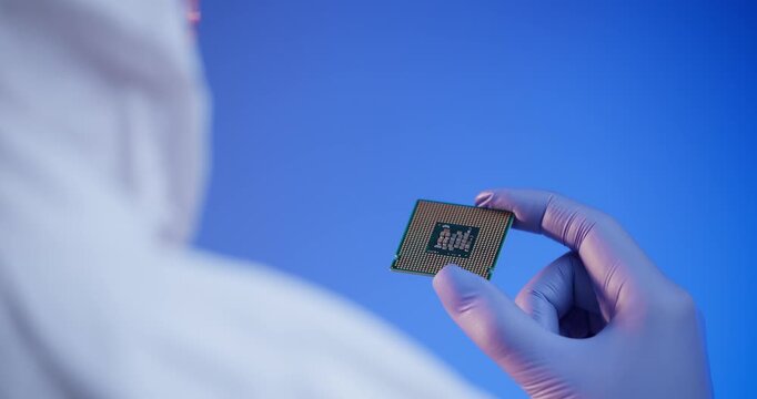 Gloved hands examining processor chip in laboratory environment, tech for artificial intelligence data center.