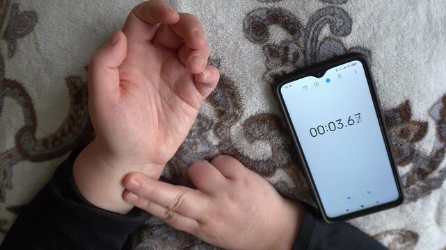Heart rate measurement with a phone.People use smartphones to measure their heart rate, digital technologies to monitor their health and fitness, and a modern lifestyle.