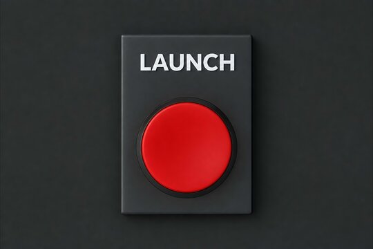 Close-up of gray launch button with red circular indicator on dark background