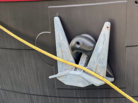 Galvanized Boat Anchor with Yellow Mooring Rope Mounted on Dark Ship Hull &mdash; Antwerp, Belgium