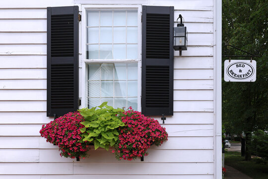 Old fashioned bed and breakfast hosting in a white clapboard house