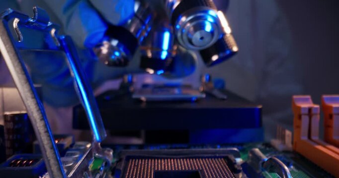 Tracking shot probe view of microchip and motherboard components being inspected and aligned under microscope on electronics laboratory bench, ai data center.