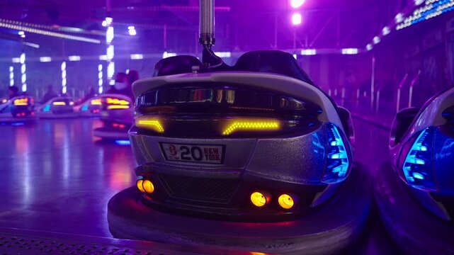 Munich, Germany. Fast bumper cars action at Theresienwiese amusement ride. Excitement and laughter as people steering dodgems through smoke machine atmosphere at Munich funfair.