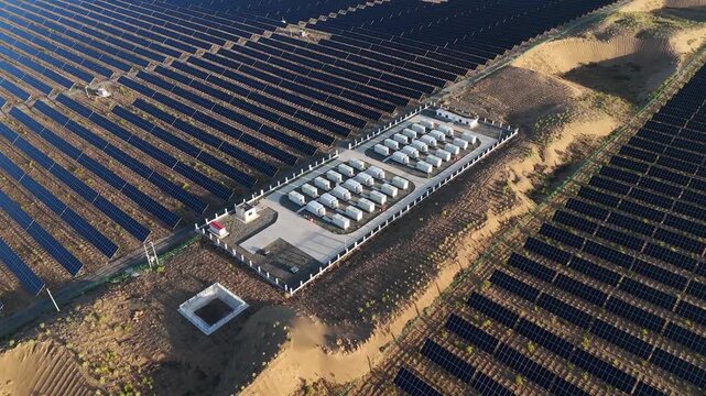 Aerial view of solar panel arrays and energy storage power station facilities