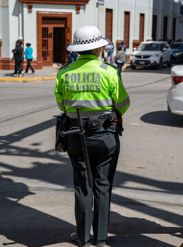 Huancayo, Per&uacute;, Peru : A traffic police officer stands beside a car at an urban intersection. A pedestrian countdown signal marks daily road control in the Peruvian Andes.