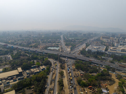 Aerial view of Atal Bihari Vajpayee Sewri-Nhava Sheva Atal Setu bridge spanning the landscape with heavy traffic and urban infrastructure in Mumbai, Maharashtra, India.