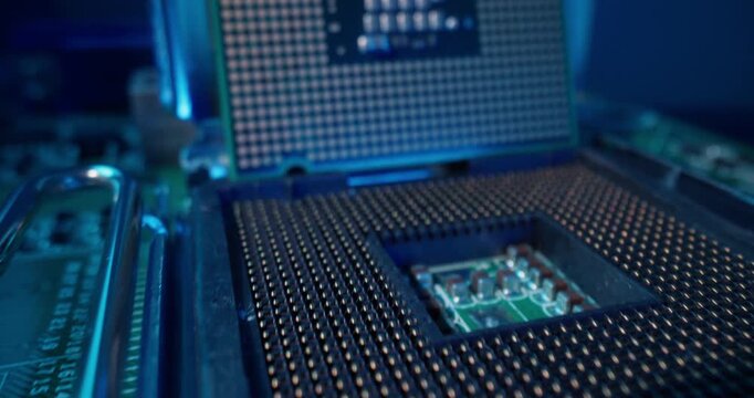 Macro panning close up of AI processor cpu socket and motherboard components in electronics workshop.