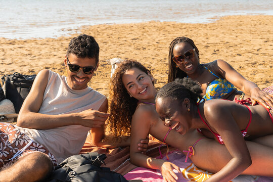 Friends Enjoy Time Together on the Beach During a Sunny Day