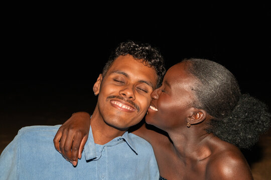 Couple Enjoys Playful Moment at Night on the Beach