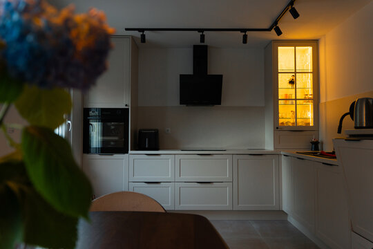 Minimalist Kitchen Interior with Warm Display Cabinet Lighting