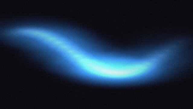 Abstract blue light wave glowing on a dark background with soft grain texture effect