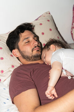 Father and Baby Sleep Together in a Cozy Setting at Home