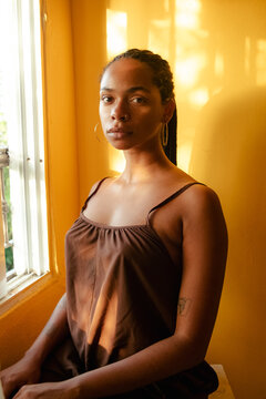 Young Black woman portrait in golden light