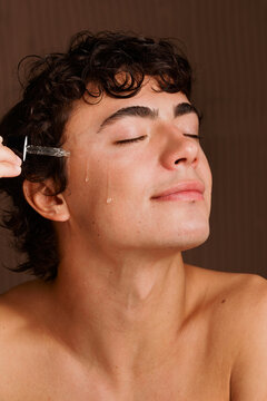 Young Man Receiving Facial Treatment in Beauty Salon
