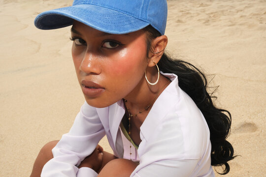 Thoughtful Woman Sitting on Sandy Beach