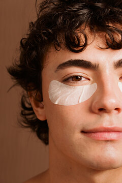 Man Applying Under-Eye Patches at Home During the Day