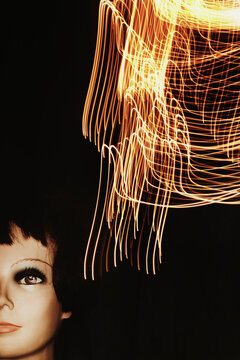 Mannequin Head With Light Trails in Dark Space