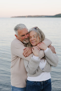 Older couple embracing by the sea, a candid moment of love