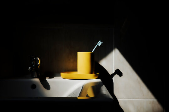 Toothbrush and Holder on Sink in Bathroom