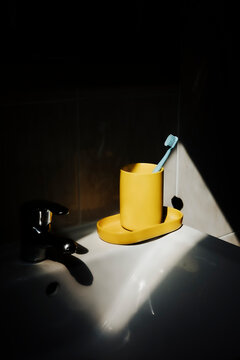 Toothbrush and Holder on Sink in Bathroom