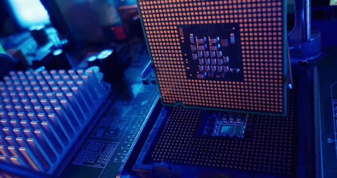 Tracking shot of AI processor and cpu socket on motherboard in electronics workstation.