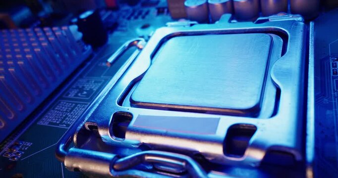 Macro probe view of cpu processor being secured into motherboard socket inside computer case.