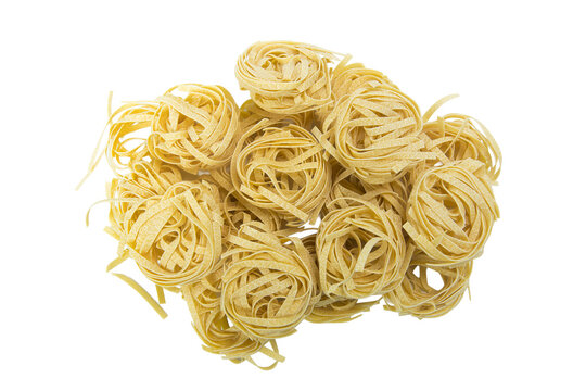 A pile of four nests of dry fettuccine pasta