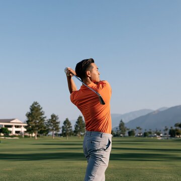 Golfer completing a backswing on manicured fairway for sports poster and golf club background