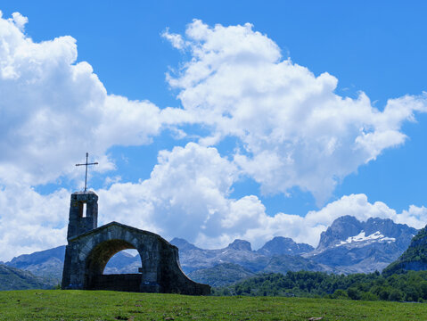 Buen Pastor Hermitage in Enol Valley with Picos de Europa Mountains, Asturias, Spain