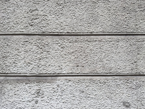 Rough Grey Stucco Wall Texture Background with Horizontal Rusticated Lines Close Up