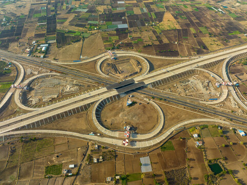Aerial view of the Sinnar Interchange featuring a complex highway junction surrounded by agricultural fields and rural landscape in Sinnar, Maharashtra, India.