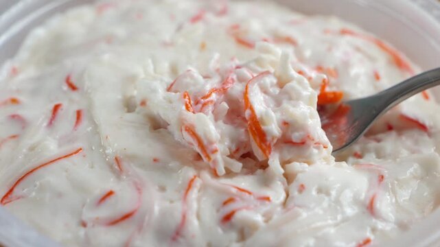 Close-up of creamy crab spread showing the delicate texture and pieces of crab meat. High quality 4k footage