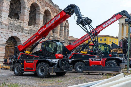 Red Manitou Telehandlers Heavy Machinery outside Roman Amphitheater Arena Wall in Verona, Italy - June 25, 2026