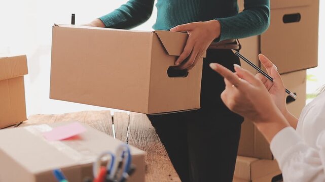 Young asian business woman startup sme small business entrepreneur SME distribution warehouse with parcel mail box. SME Online marketing and product packaging and delivery service.