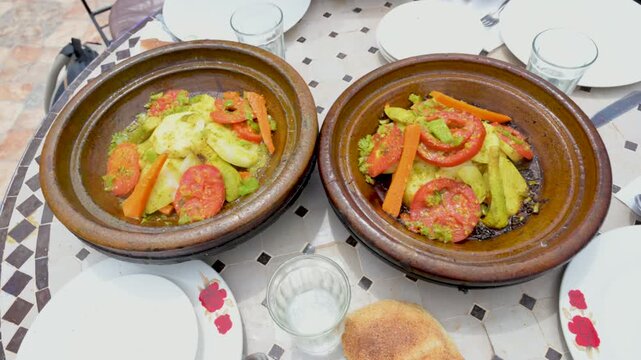 Marrakech, morocco. August 9, 2026. Delicious and hot vegetable tagine dishes served on a traditional mosaic table. A healthy and savory meal from authentic moroccan cuisine