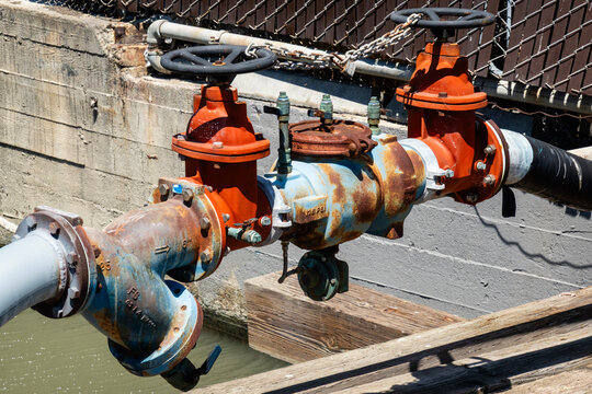 valves-A complex network of industrial metal pipes and red-wheeled control valves