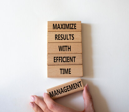 Concept words maximize results with efficient time management on wooden blocks. Businessman hand. Beautiful white background. Business concept. Copy space.