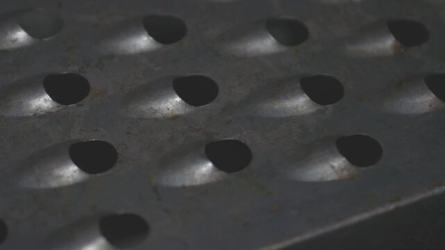 A close-up of a grater with holes, suitable for food or decoration use