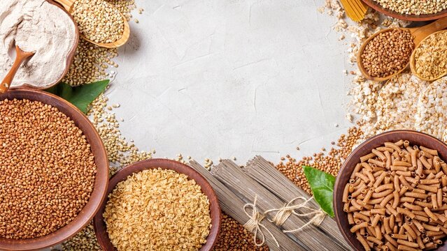 Rural still-life, top view - the peeled groats of buckwheat (Fagopyrum esculentum) and products made from it, as background, closeup