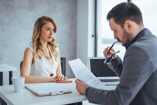 Business Interview Between Female Candidate and Hiring Manager in Modern Bright Office Setting