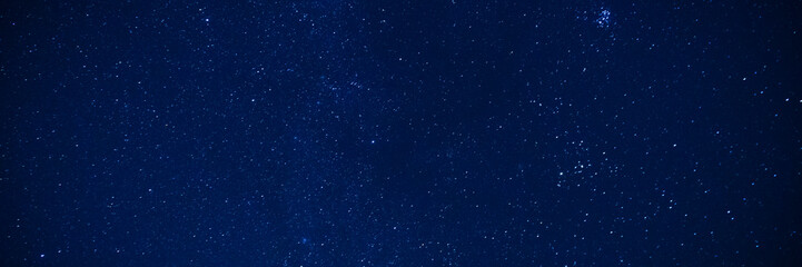 Deep blue starry night sky filled with countless stars and subtle celestial patterns. Wide panoramic space background for banners, website headers, astronomy designs and creative projects © hannamartysheva