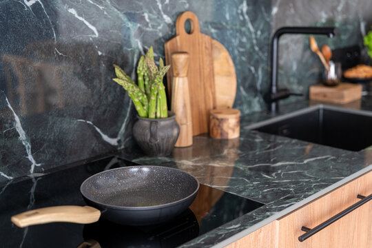 Induction hob placed on countertop in a modern kitchen setting