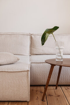 Modern living room with white couch and wooden table in apartment
