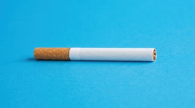 Single Cigarette Against Bold Blue Background Clean Studio Shot