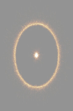 Glowing golden fiery ring portal overlay on grey background. Abstract golden light circle frame with central starburst photo overlay. olden ring of fire magic portal