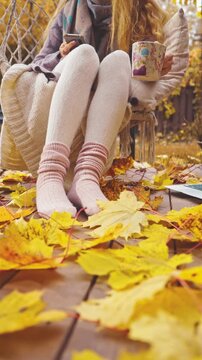 Autumn home office mood with coffee, laptop, and cozy socks. Peaceful fall morning atmosphere, freelance work and slow living lifestyle with comfort and productivity.