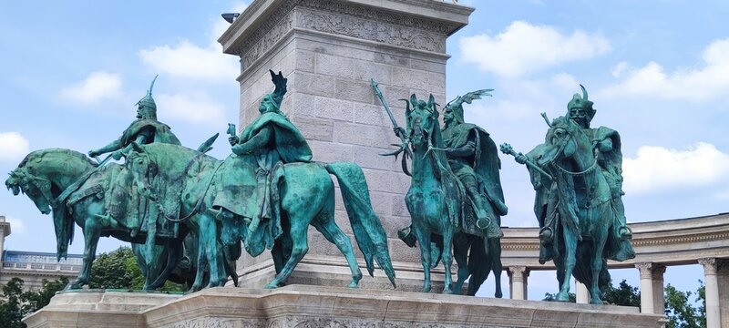 Budapest, Hungary - 26 June 2024, Bronze statues of horse riders stand atop a monument at Heroes' Square in Budapest